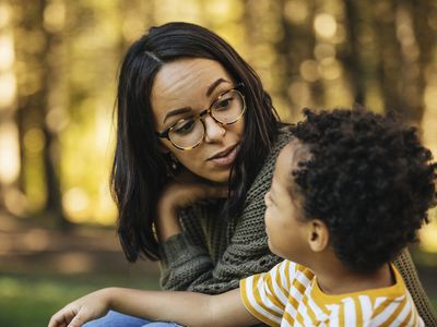 Mother talking to son outdoors