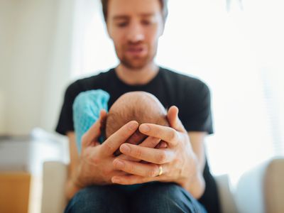 Man holding newborn baby