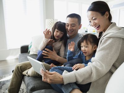 Family waving at iPad