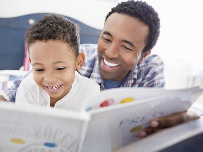 Verbally gifted boy reading with his father