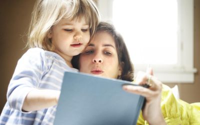 Mother reading to daughter.