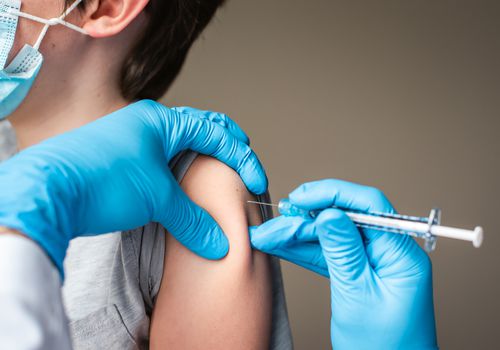 Child getting a shot in the arm