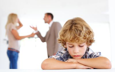 Young boy listening to his parents fighting