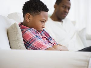 Father and son arguing on sofa