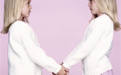 Twin girls holding hands