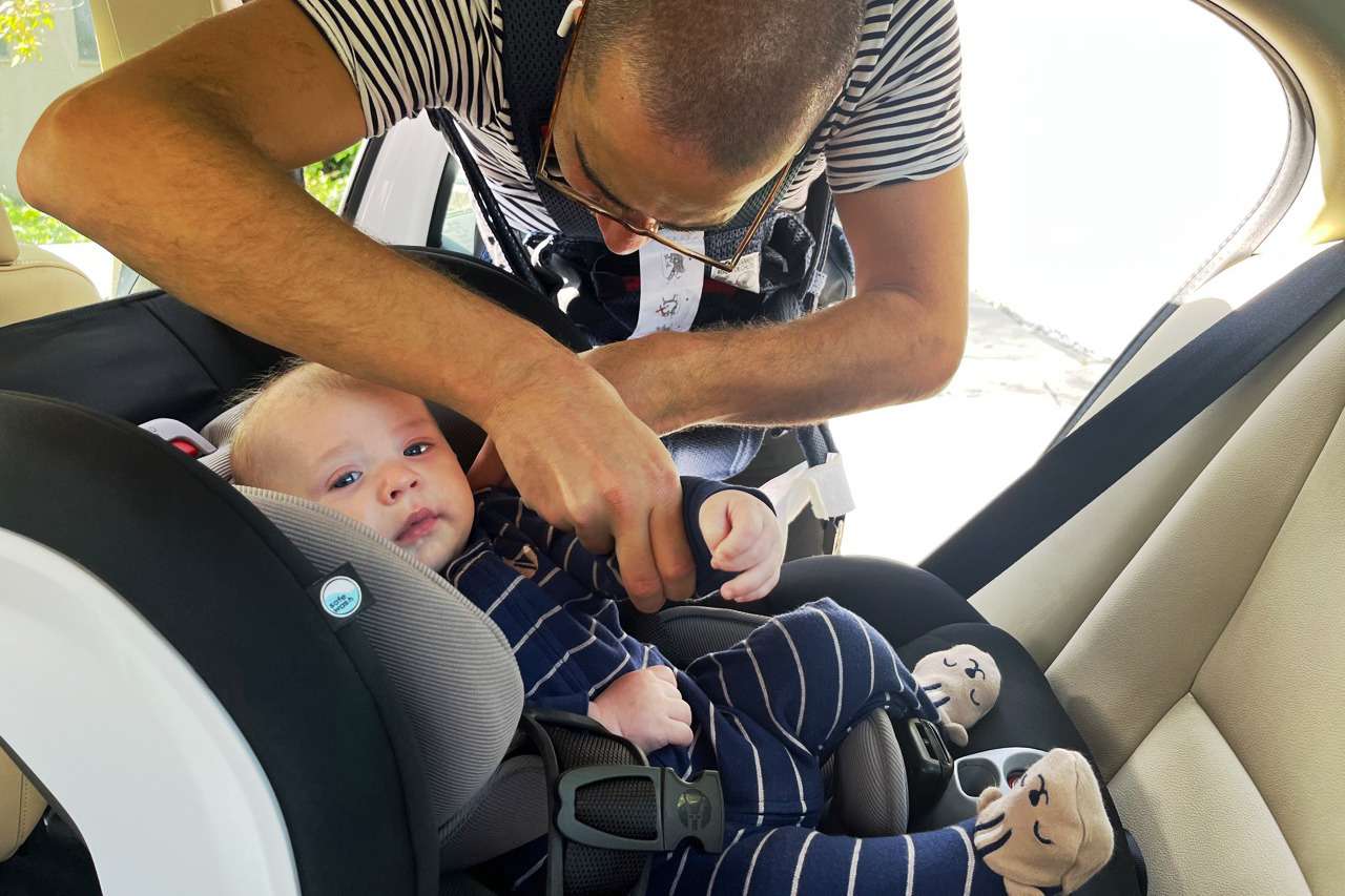 Person securing their child in the Britax Boulevard ClickTight Convertible Car Seat