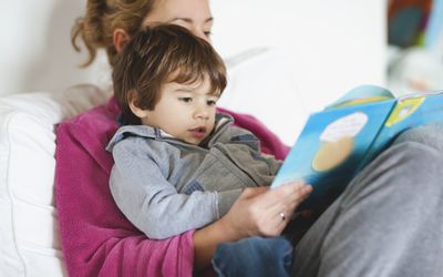 mother and boy reading book