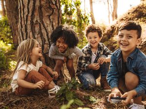 cute children playing in the forest