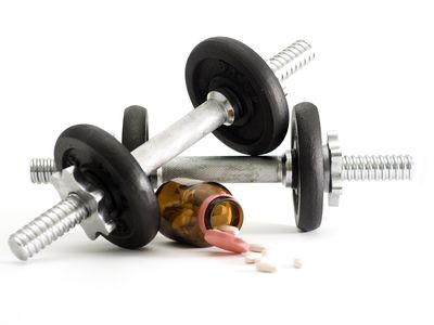 Dumbbells with bottle of Clomid used for doping