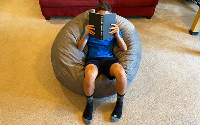 Boy reading in CordaRoy Chenille Bean Bag Chair