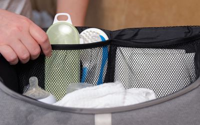 person packing a diaper bag