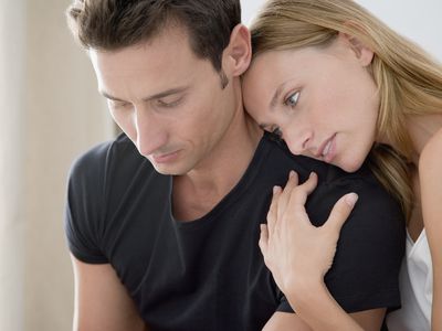 Couple comforting each other through infertility, having decided against going through IVF