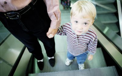 YOUNG BOY WITH MOTHER ON ESCALATOR