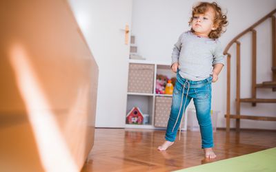 Toddler pulling up their own pants