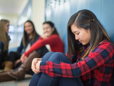 Girl getting bullied in high school hallway