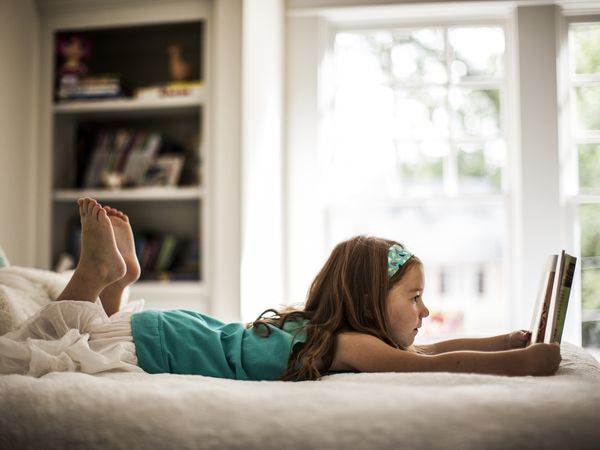 Girl reading on her bed