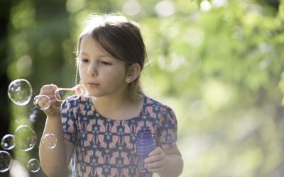 Little girl blowing bubbles