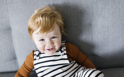 smiling baby boy in striped overalls