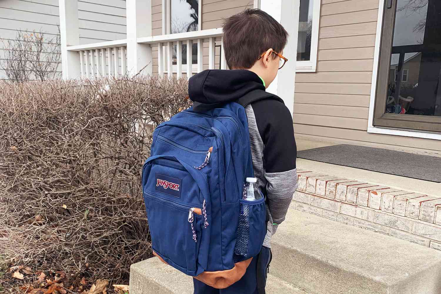 A child wearing the JanSport Cool Student backpack