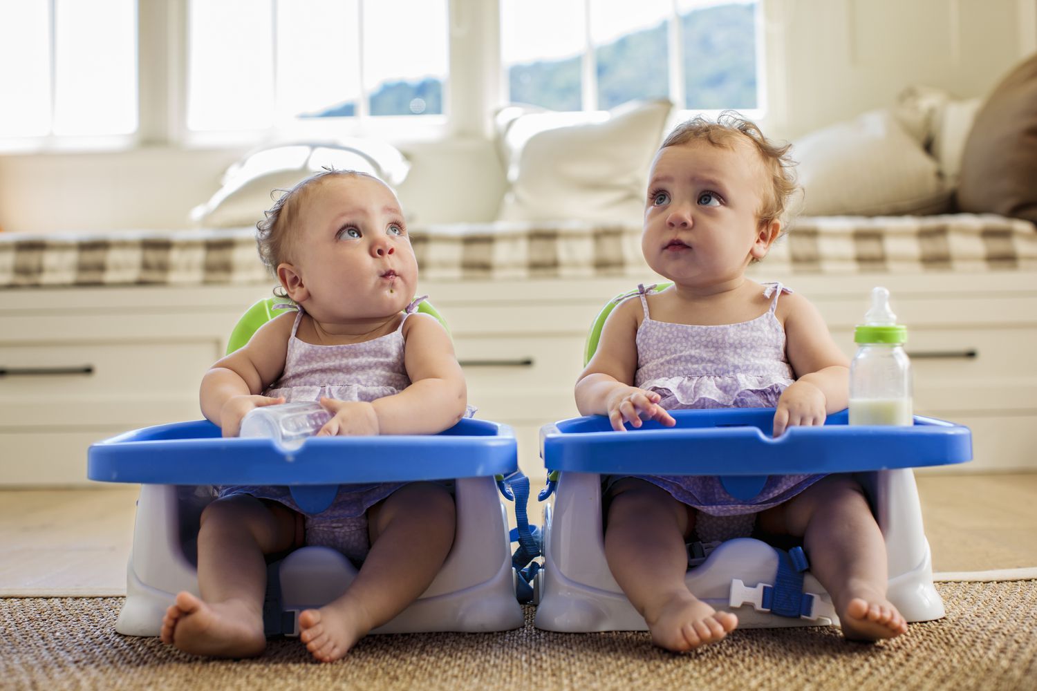 Twins sitting with milk