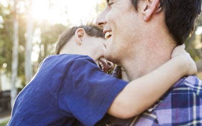 a father and son laughing＂width=