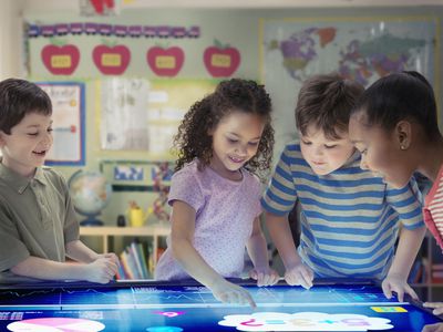 Students using a digital tablet.