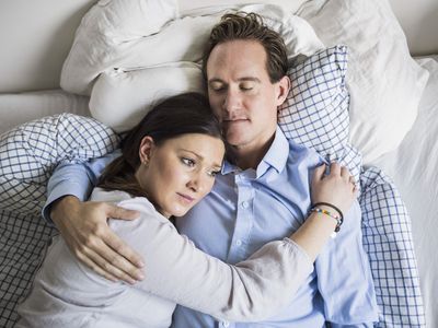 Sad couple in bed