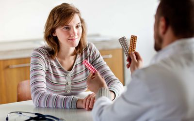 Teen talking to doctor about sexual health