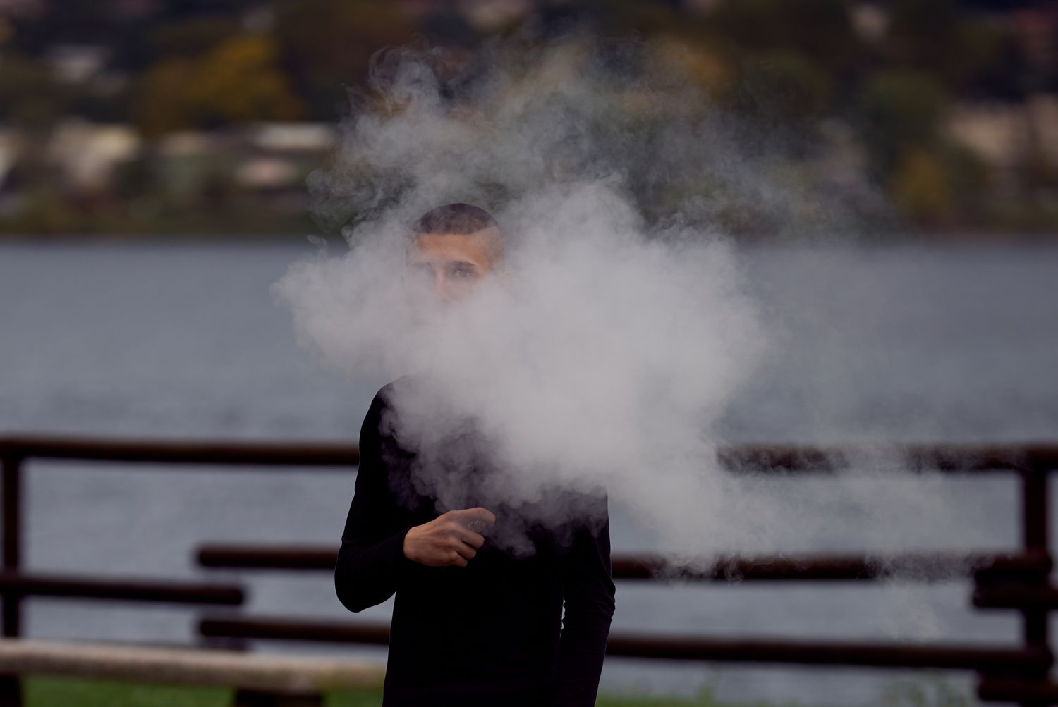 Teenager in a cloud of vape smoke