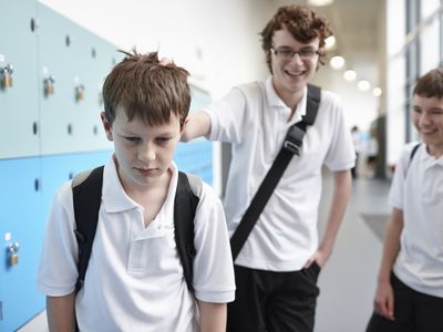 middle school boy being bullied in hallway near lockers