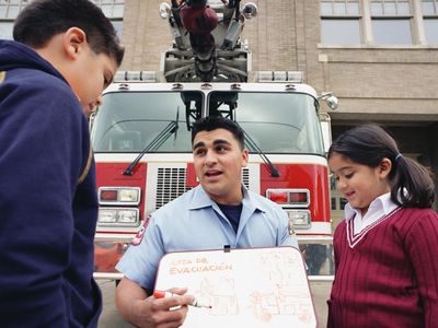 Fireman talking about evacuation routes to children