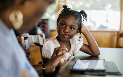 Young girl gets help at school