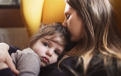 Little girl in mother's arms