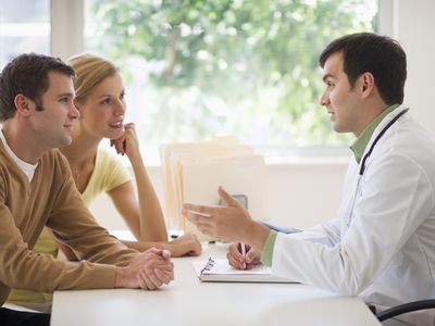 Couple talking to a doctor about infertility