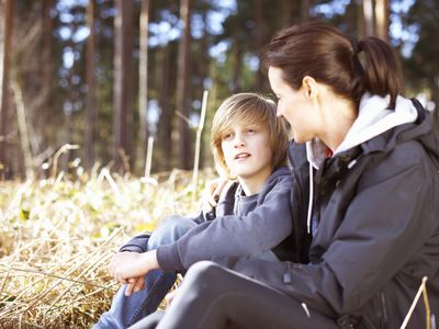 Mature woman taking a break with her son in a forest