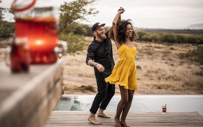 Man and woman dancing by the water