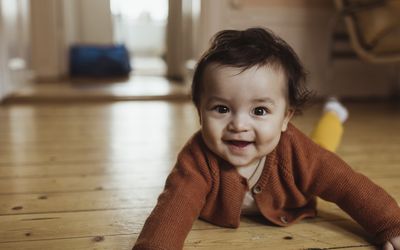 Smiling toddler lying on the ground