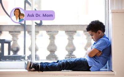 Ask Dr. Mom logo on a photo of a child sitting in time out