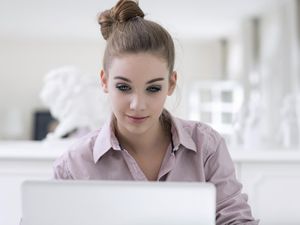 Portrait of teenage girl using laptop