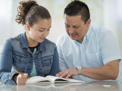 High schooler and Dad reading book