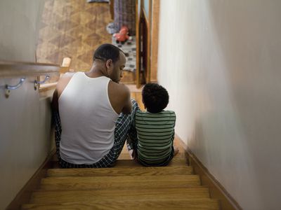 Father sitting with son on the stairs