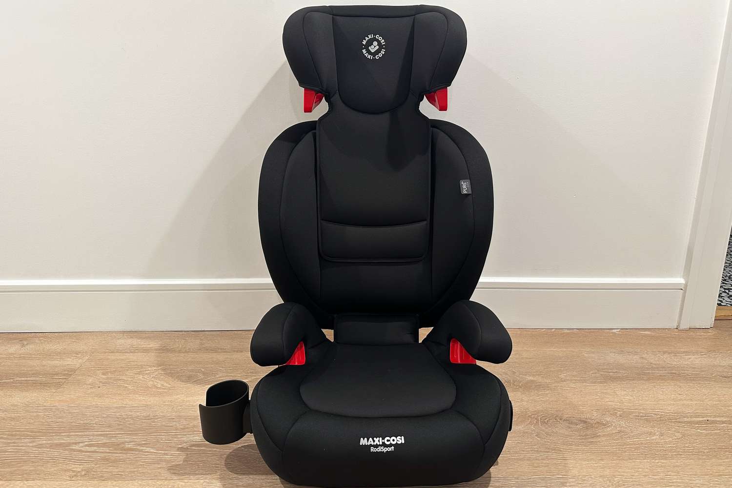 The Maxi-Cosi RodiSport Booster Car Seat on a wood floor