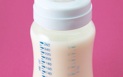 Bottle of milk with pink background