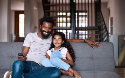 father and daughter watching tv