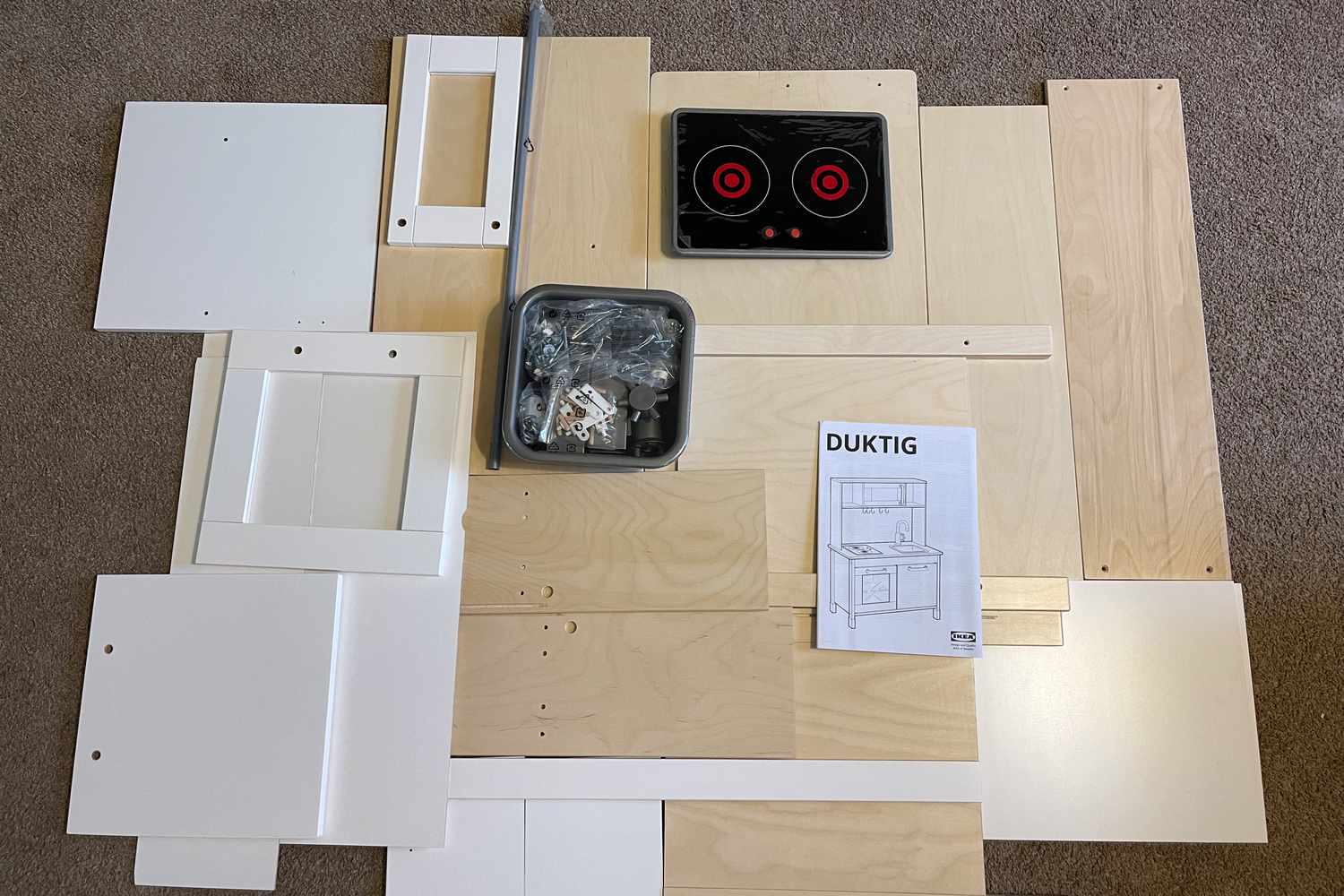 Parts of IKEA Duktig Play Kitchen on table