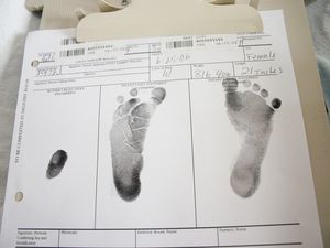 birth paperwork including baby's footprints