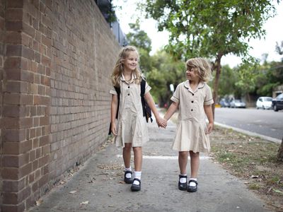 Two young girls walking to school