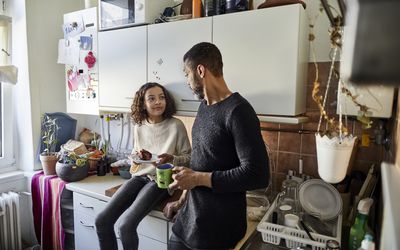 father and daughter talking in kitchen