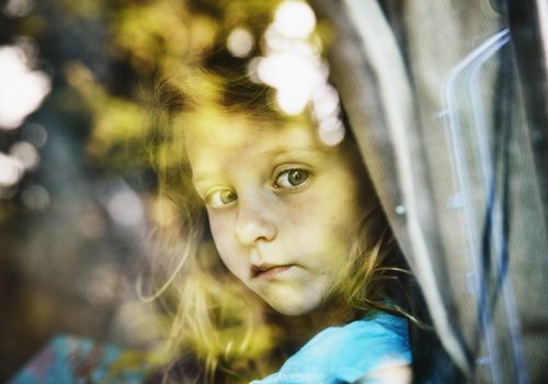 little girl looking out from a car window