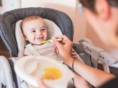 Mother feeding baby with a spoon